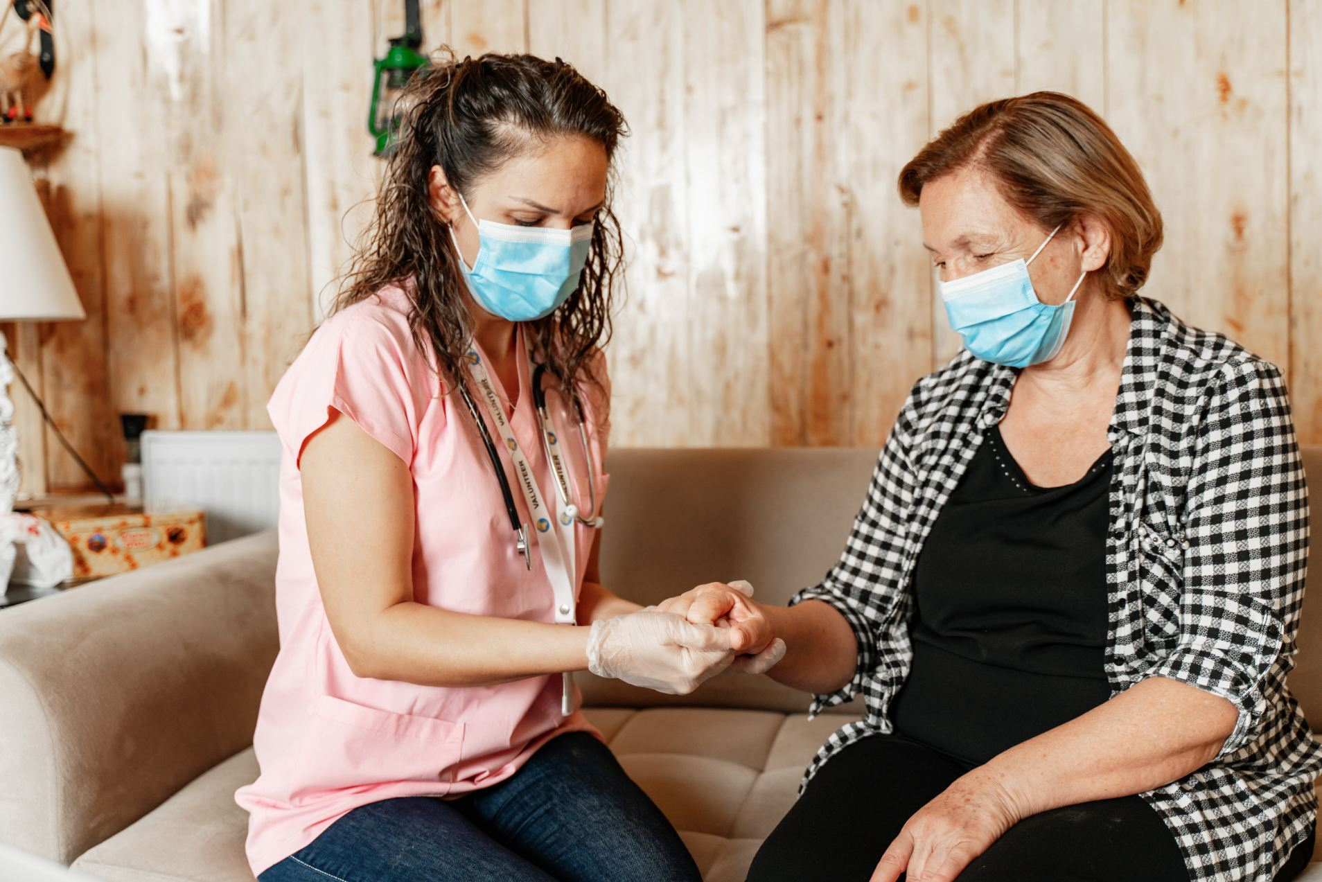 nurse woman masks couch hands