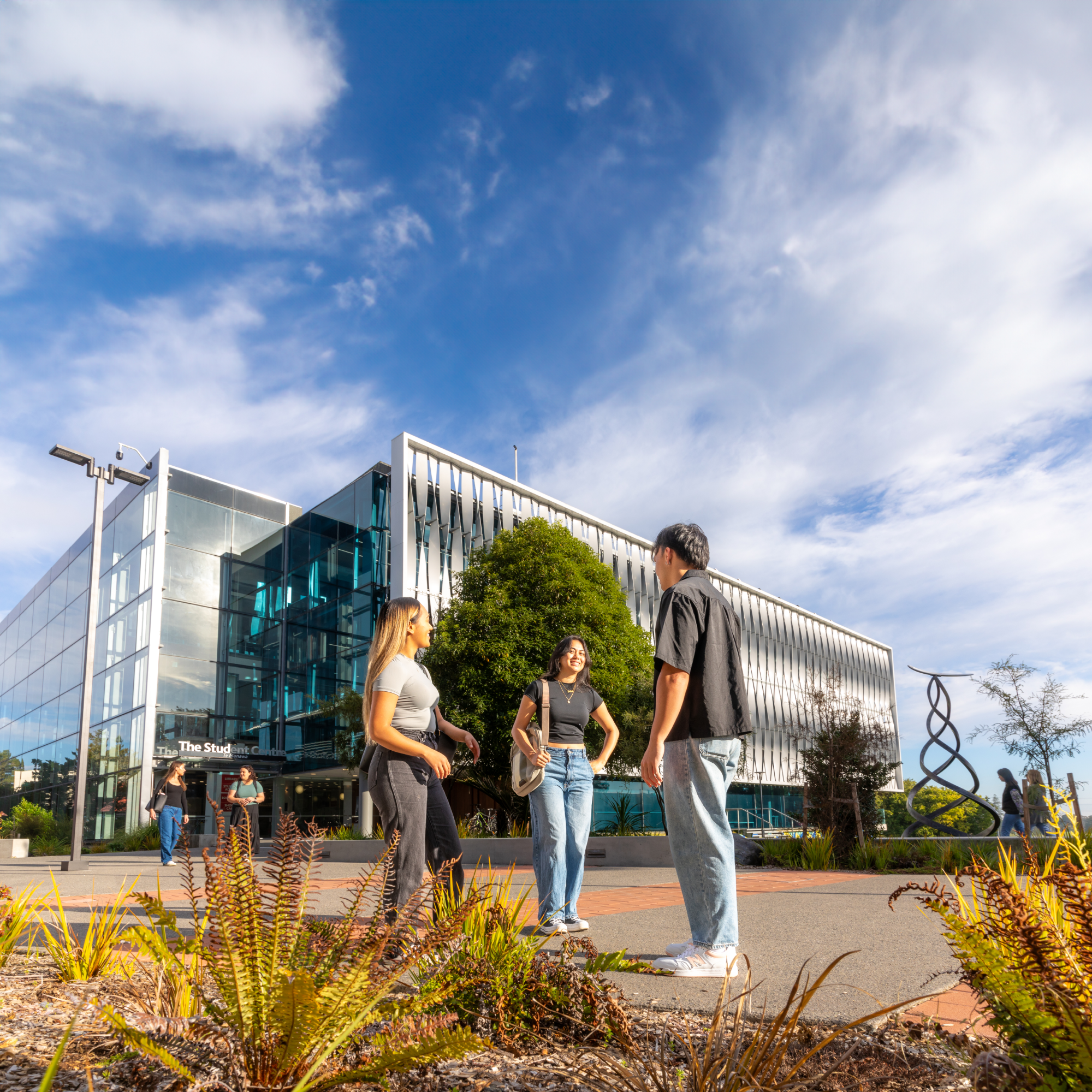 students-standing-around-outside-library