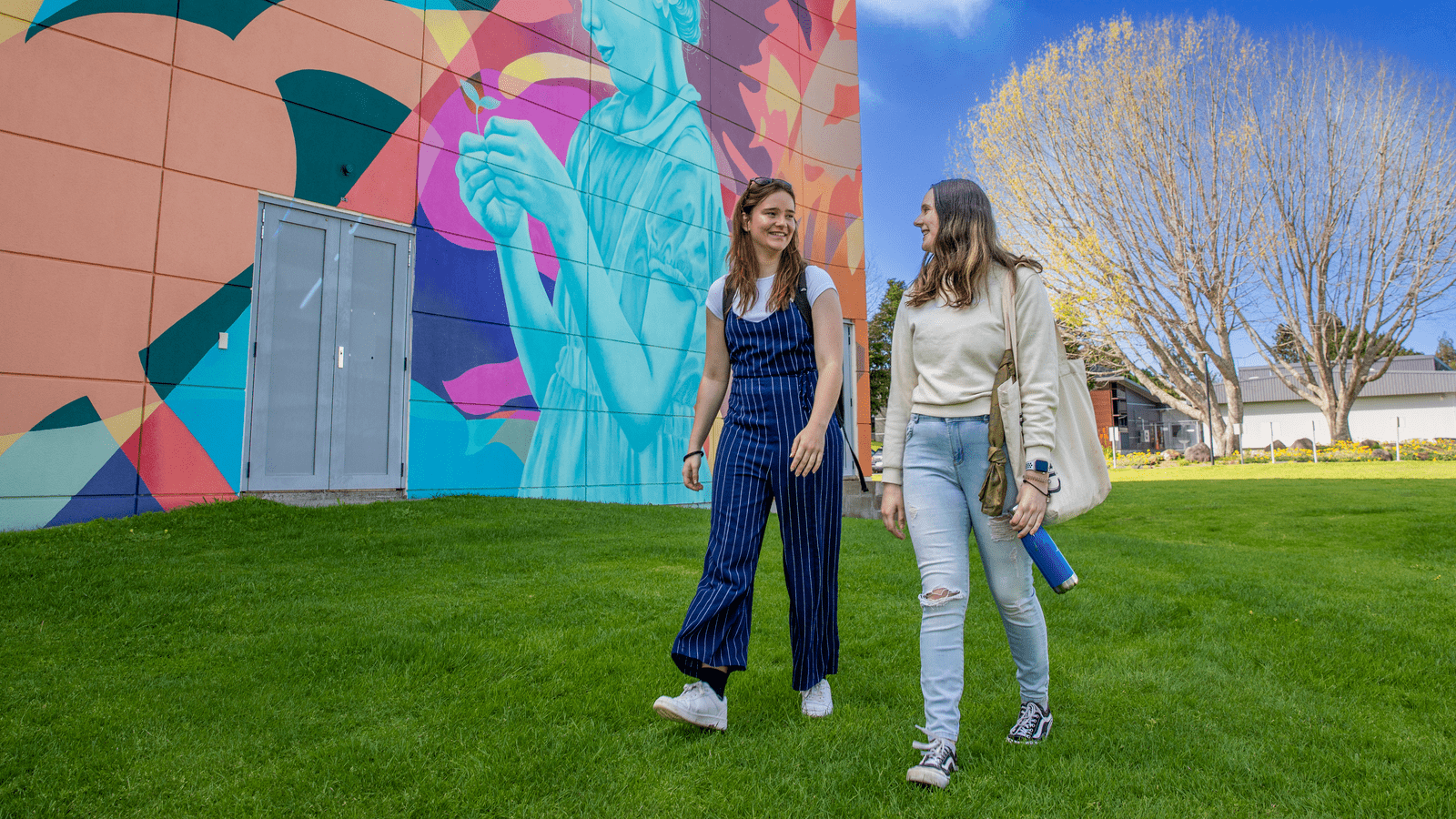 two-students-walking-together-outside